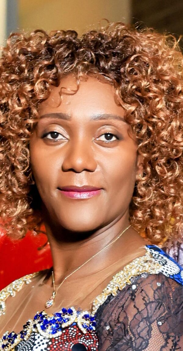 Portrait of a woman with curly hair and a calm expression.